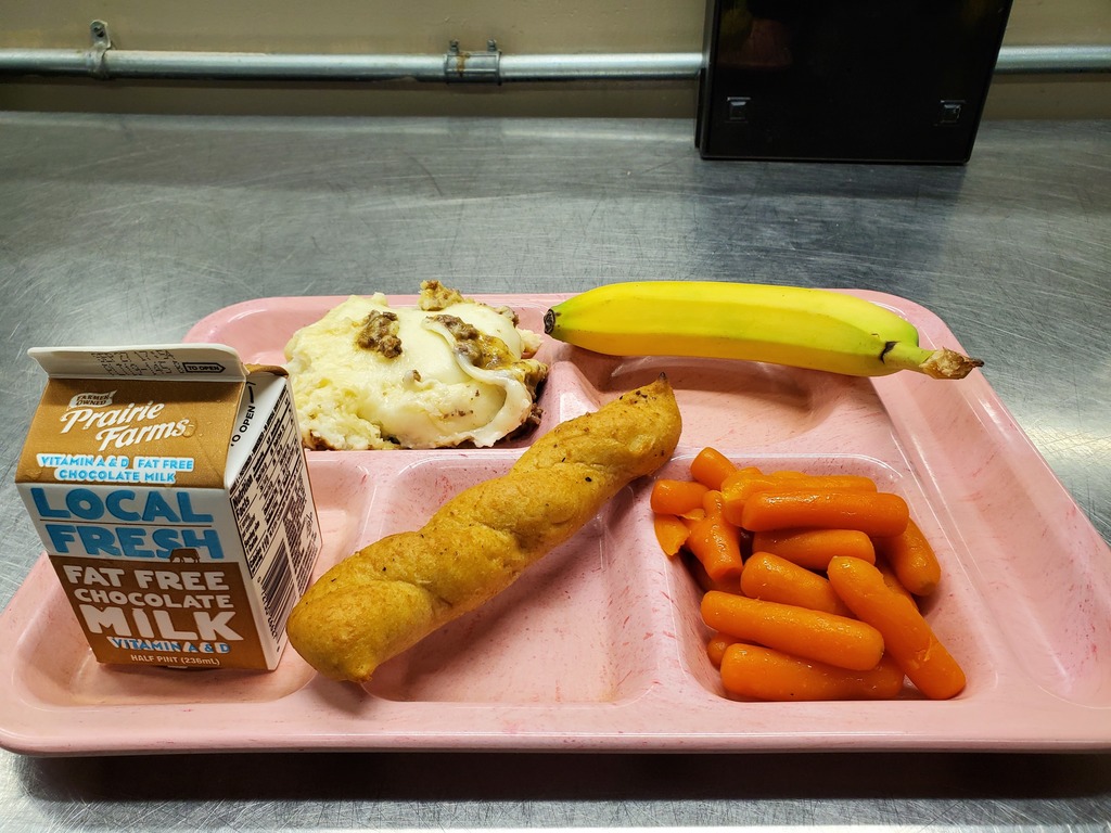 Healthy lunch tray of our homemade Shepherds Pie, Glazed Carrots, Whole Grain Bread Stick, and a fresh banana! 