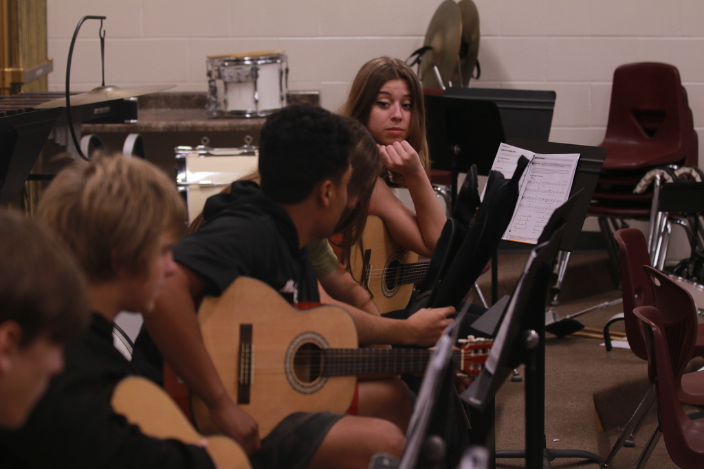 Students playing guitar.
